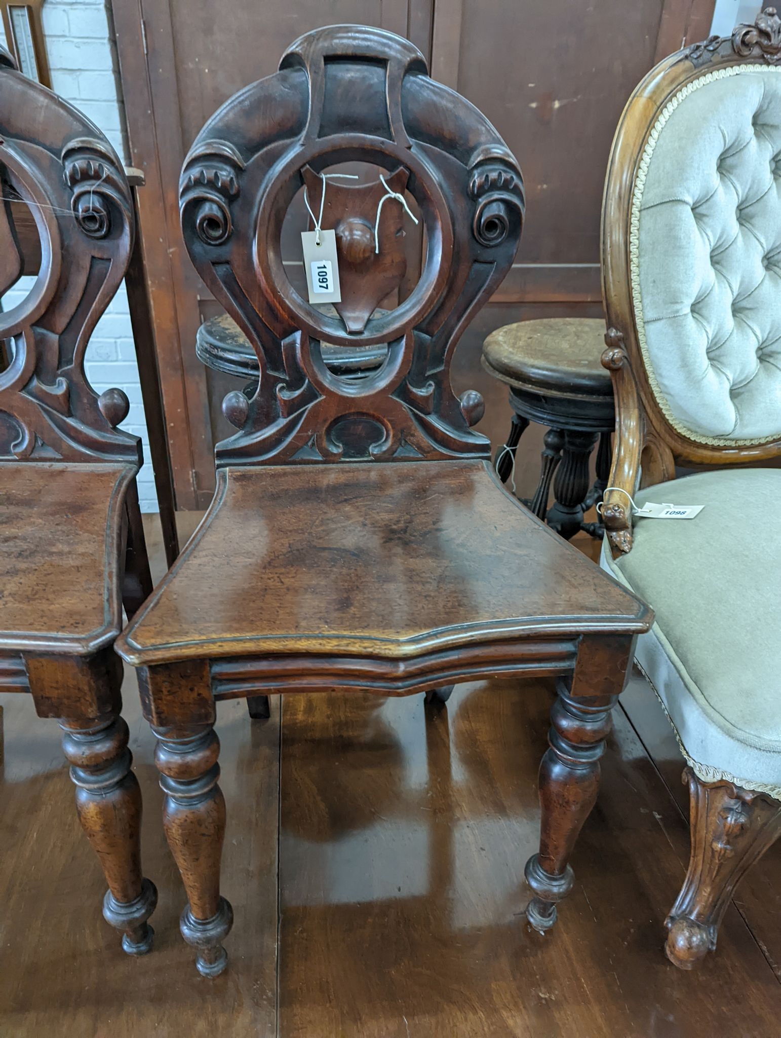 A pair of Victorian mahogany hall chairs and an oak hall chair